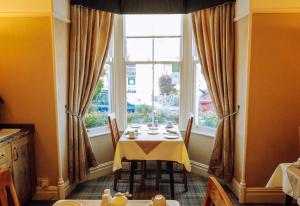 a dining room with a table and a window at Avondale Guest House in Keswick