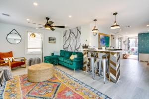 sala de estar con sofá azul y cocina en Renovated Seaside Park Cottage Steps to Beach!, en Seaside Park