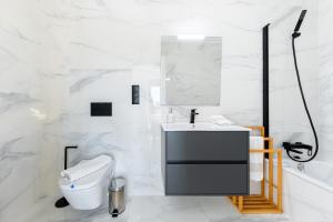 a white bathroom with a sink and a toilet at Moderna Casa VillaCristal in Daya Vieja