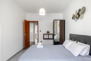 um quarto com uma cama grande e lençóis brancos em Sleeptubal Moderne Accommodatie em Alhos Vedros
