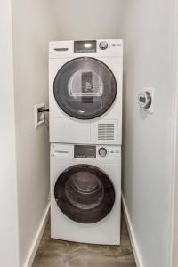 a washer and dryer in a small room at Brand New Stylish Studio Suite Near Downtown in Oakland
