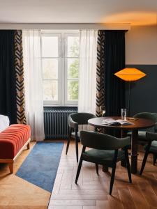a room with a table and chairs and a window at The Hoxton Lloyd Amsterdam City Centre East in Amsterdam