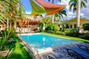 a swimming pool in the backyard of a house at Hotel Enjoy in Las Terrenas