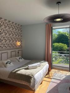 - une chambre avec un lit et une grande fenêtre dans l'établissement Domaine Clairfontaine Noyarey - Suites Junior, à Noyarey