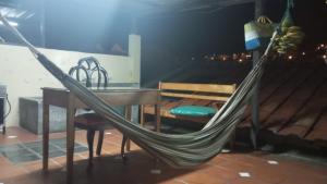 a hammock with a table and a table and a bench at Mini suite in Loja