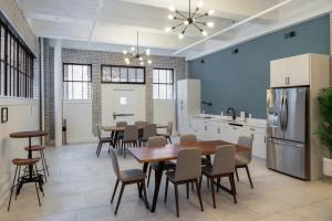 a kitchen with a dining room with a table and chairs at The Ledger Residences by Sosuite - Old City in Philadelphia