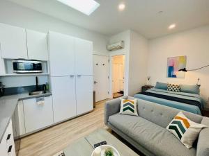 a living room with a couch and a bed at Fully-Stocked Studio Suite Near Downtown Oakland in Oakland