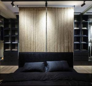 a bedroom with a bed and a wall with shelves at Feel in forest in Vilnius