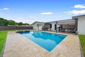 a swimming pool in the backyard of a house at Private Spacious House #BBQ - Hallandale Beach, Florida in Hallandale Beach