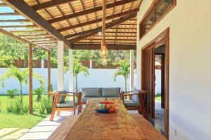 Une table et des chaises en bois sont disponibles sur la terrasse. dans l'établissement Casa em Jijoca de Jericoacoara por Carpediem, à Jericoacoara