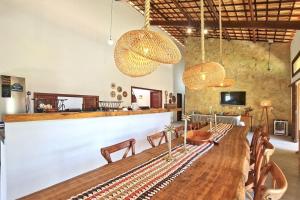 a dining room with a long table and chairs at Chalés em Jericoacoara por Carpediem in Jijoca de Jericoacoara +40 photos