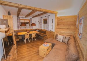 a living room with a couch and a table at Alpinchalet Apartment Alpenrose in Ortisei