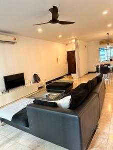 a living room with a couch and a ceiling fan at The Corinthan in Kuala Lumpur