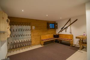 a room with two benches in a hockey rink at Alpinchalet Apartment Alpenrose in Ortisei