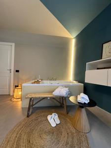 a bathroom with a sink and a table with slippers at VILLA CHIARA in Torre Orsina +63 photos