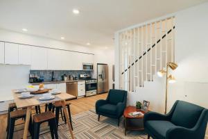 a living room with a table and chairs and a kitchen at Luxury Apt in West Oakland - Near Downtown in Oakland