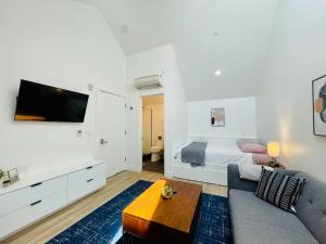 a living room with a couch and a bed at Luxury Apartment in West Oakland - Near Downtown in Oakland