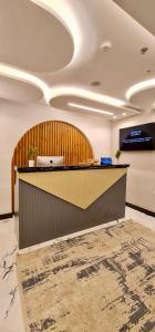 an office lobby with a reception counter and a television at Peace Inn West Pyramids Cairo in Cairo