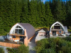 an overhead view of two houses with trees in the background at Jill Strawbale House- Ukc2935 in Strontian