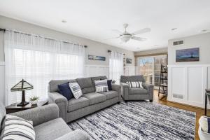 a living room with two couches and a rug at Beautiful Home With Water Views & Close To Ocean in Warwick