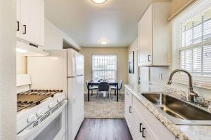 a kitchen with white appliances and a table with a chair at 2BR in Berkeley Near Campus in Berkeley