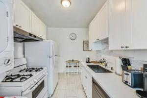 a white kitchen with a stove and a sink at Right Across From Campus 2BR 1b in Berkeley