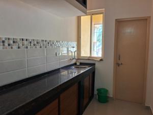 a kitchen with a sink and a counter top at Fieldstone Lovely 2 BHK AC Apartment in Talaulim