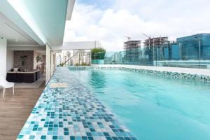 a swimming pool with a view of a building at Stunning infinity pool apartment in Santo Domingo