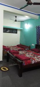 A bed or beds in a room at Nirmala Home Stay