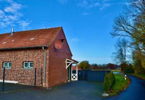 a red brick building with a white door at Bed and Bike Rheine in Rheine