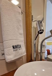 a bathroom with a white sink and a towel at NAVEGA PRAIA HOTEL in Navegantes