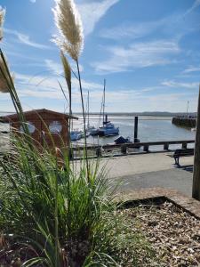 a view of a harbor with a boat in the water at gîte cœur de baie in Le Crotoy
