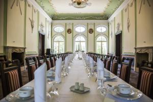 a conference room with a long table and chairs at Palace Popowo Stare in Stare Popowo