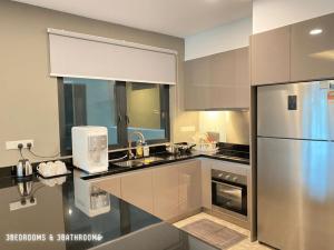 a kitchen with a sink and a refrigerator at Genting Highlands Vista Residences Free Wi-Fi & 1 Parking in Genting Highlands
