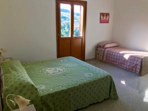 a small room with two beds and a window at i 3 falchi Bed & Breakfast 