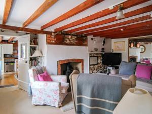 a living room with two chairs and a fireplace at Southview Cottage in Newbridge