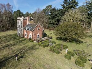an aerial view of an old house in a field at Falconer's Lodge in Didlington