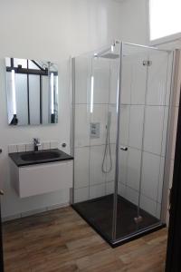 a bathroom with a shower and a sink at Aupetitclos in Vincennes