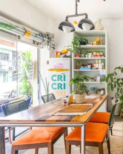 a dining room with a table and orange chairs at Beach Apartment in Tel Aviv