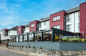 a row of buildings on a city street at Claregalway Hotel in Claregalway