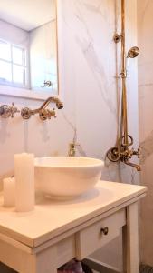 a white bathroom with a sink and a mirror at La Flor del Camino Posada in Tanti