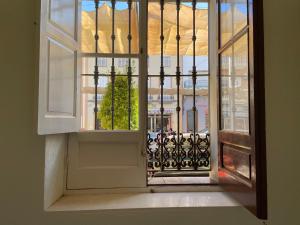 an open door with a view of a building at Patios de la Carmela in Isla Cristina