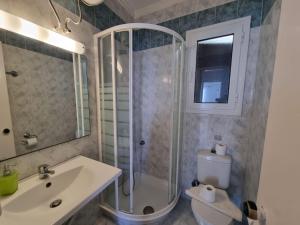 a bathroom with a shower and a toilet and a sink at Corfu Dream Holidays Villas in Corfu Town +22 photos