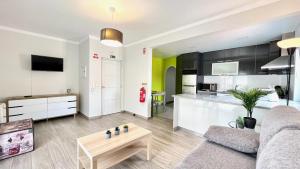 a living room with a couch and a table at Surfers Den - One Bedroom Flat - Baleal in Ferrel