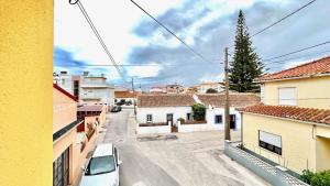a view of a street in a town with buildings at Surfers Den - One Bedroom Flat - Baleal in Ferrel