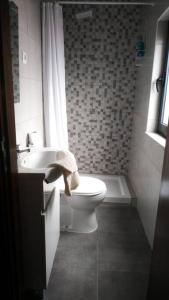 y baño con aseo, lavabo y bañera. en Casa das Matriarcas - Casa da Avó Judite, en Belmonte