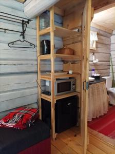 a room with a bunk bed and a microwave at White homestead in Sumiliszki