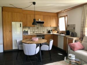 a kitchen with a table and chairs in a room at Valsart 2003 Bm in Valbella