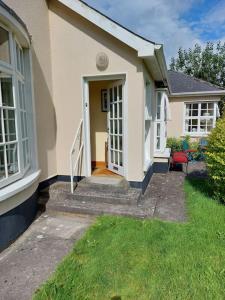 a house with a staircase leading to the front door at Lily's Place - up to 4 persons in Birr