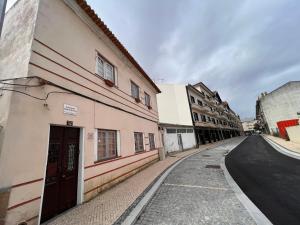 an empty street in a city with buildings at Fernando Guest House in Aveiro